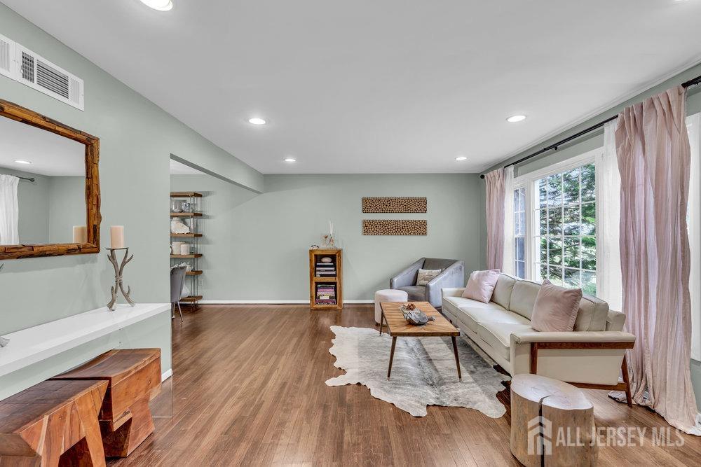 10 Kings Road East Brunswick, NJ 08816 - Photo 3 of 33 a living room with furniture and a wooden floor