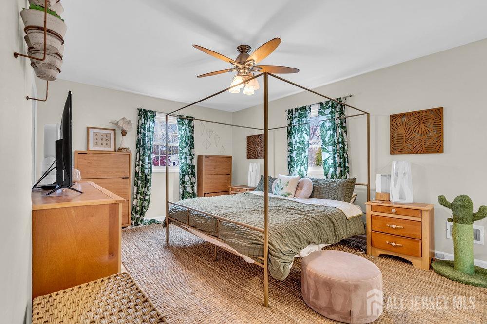 10 Kings Road East Brunswick, NJ 08816 - Photo 6 of 33 a bedroom with a bed and a chandelier