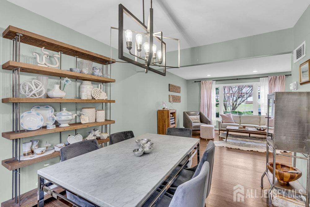10 Kings Road East Brunswick, NJ 08816 - Photo 7 of 33 a view of a dining room with furniture a rug and wooden floor