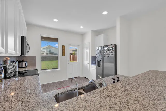 a bedroom with furniture and a flat screen tv