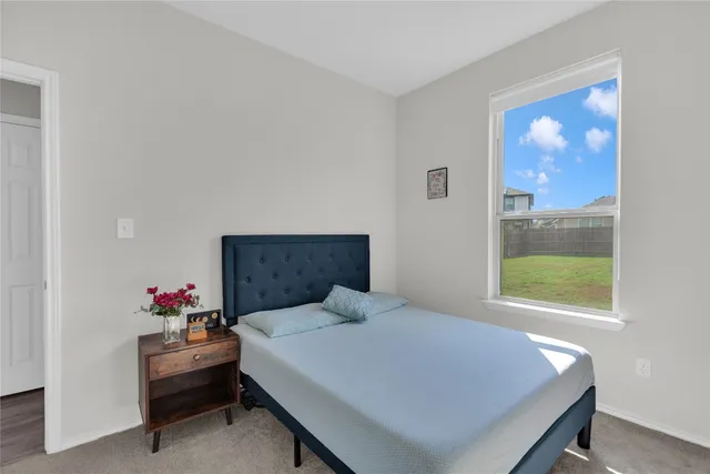 a bedroom with a bed and a potted plant