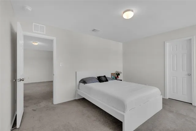 a bedroom with a bed and a night stand