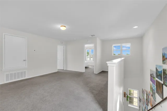 a view of empty room with window and fireplace