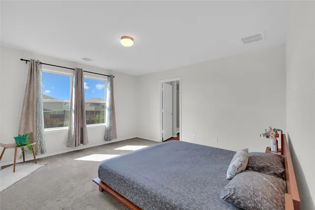 a bedroom with a bed and window