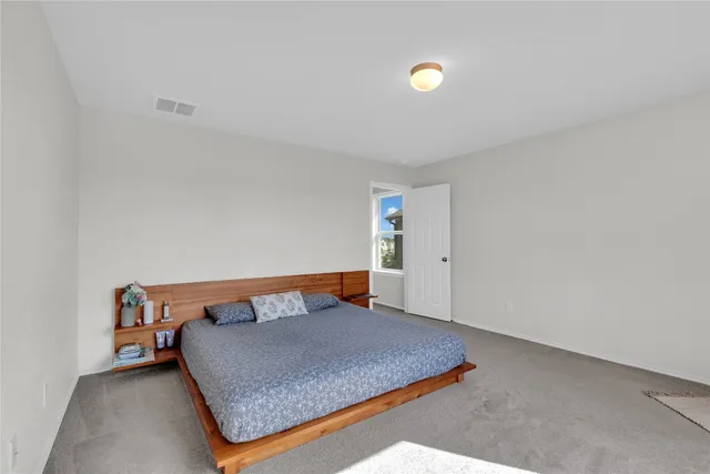 a bedroom with a bed and window