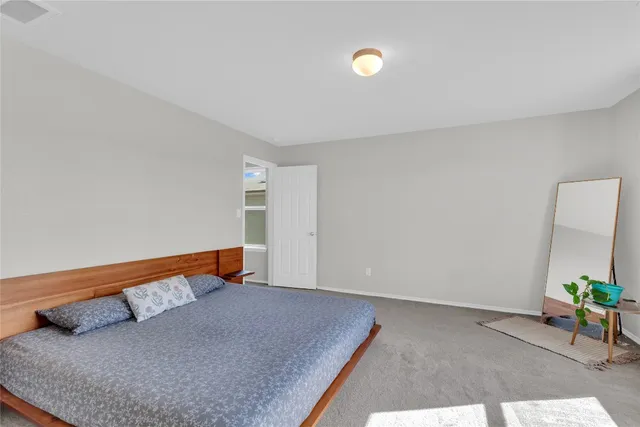 a bedroom with a bed and a potted plant on it