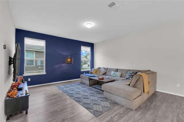 a living room with furniture chess board and a window