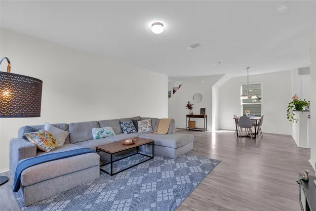 a living room with furniture and wooden floor
