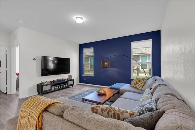 a living room with furniture and a flat screen tv