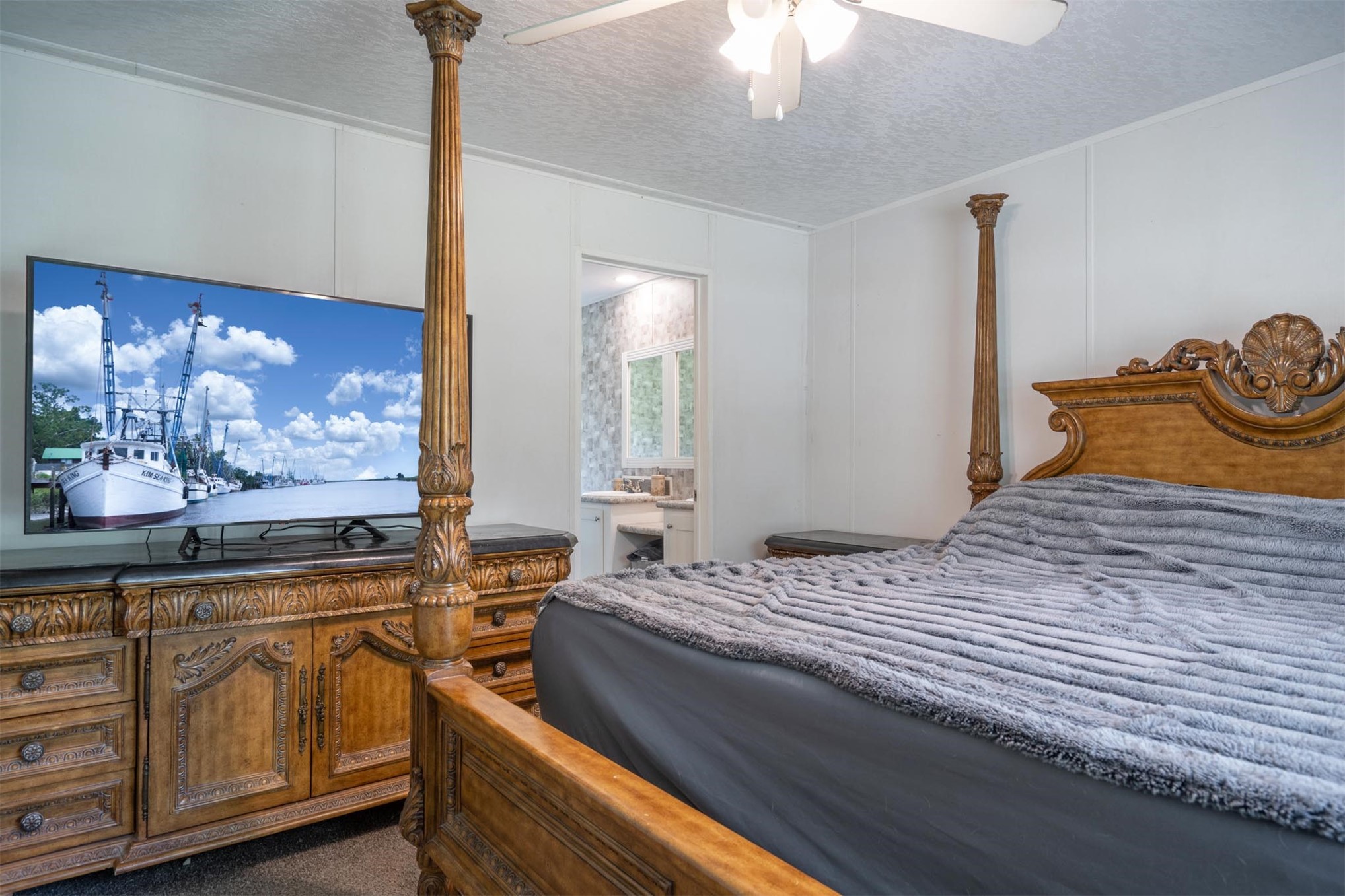 76220 Dove Road Yulee, FL 32097 - Photo 29 of 48 a bedroom with a bed and cabinet