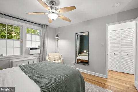 a bedroom with a bed and a large window
