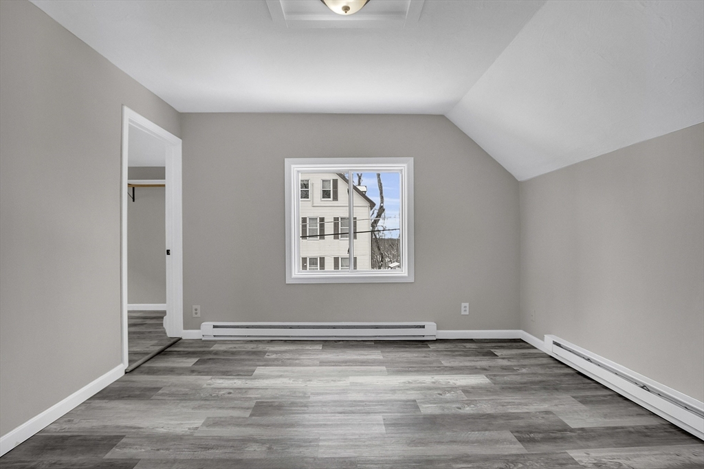 73 Ash Street Gardner, MA 01440 - Photo 12 of 40 an empty room with wooden floor and windows