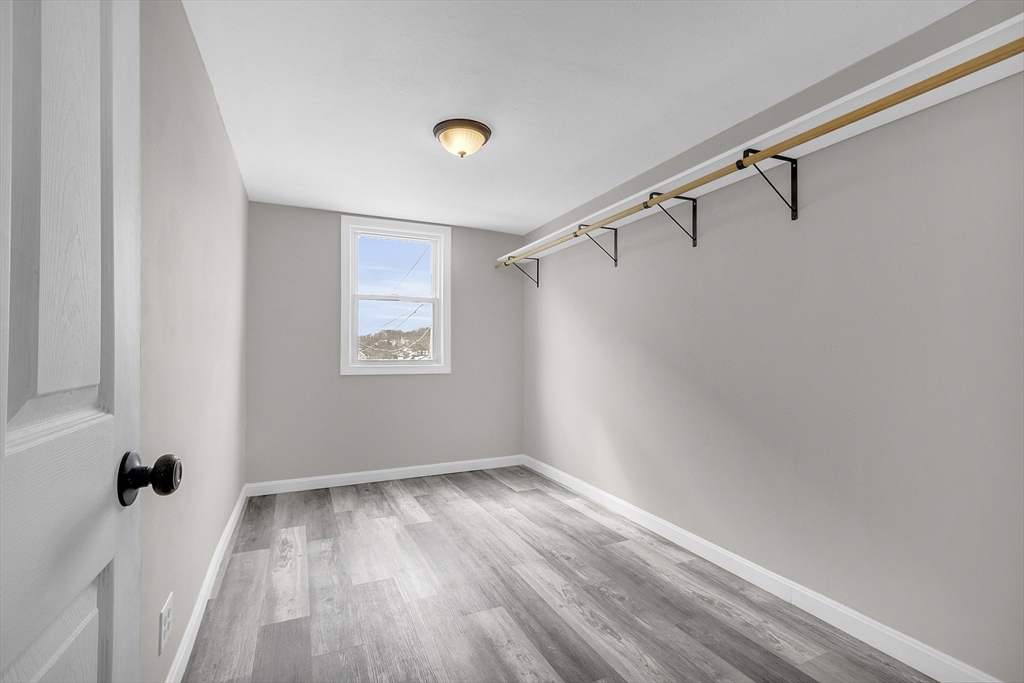 73 Ash Street Gardner, MA 01440 - Photo 13 of 40 a view of an empty room with wooden floor and a window