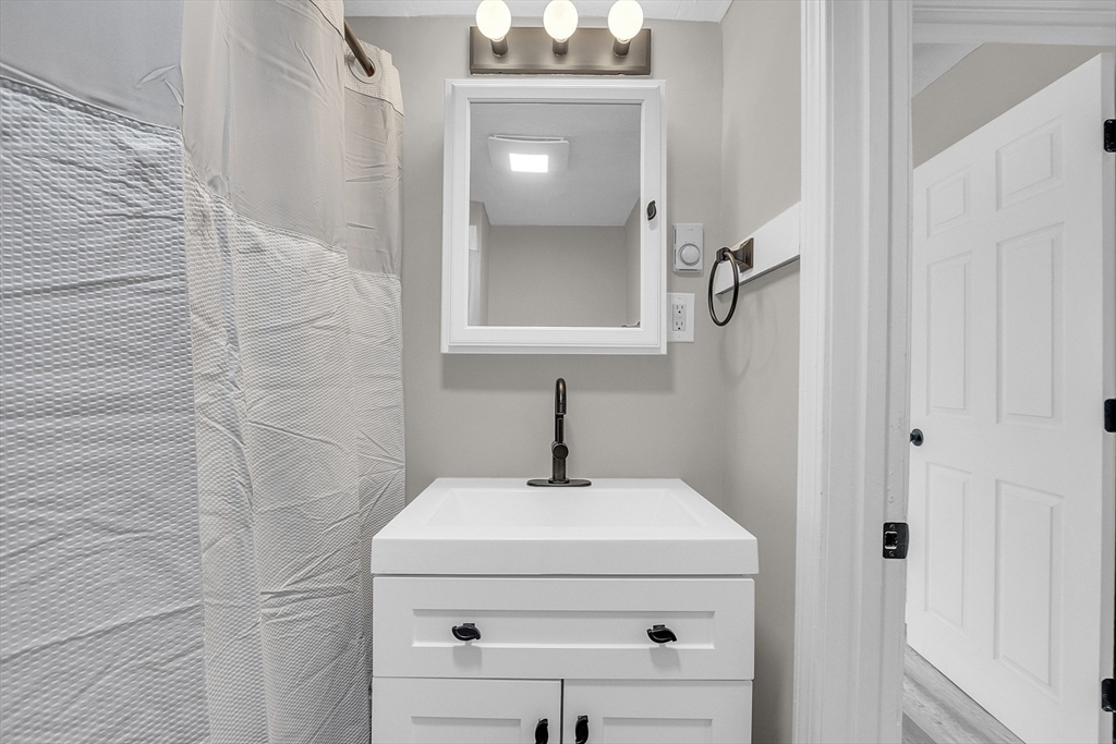 73 Ash Street Gardner, MA 01440 - Photo 15 of 40 a bathroom with a sink a mirror and vanity