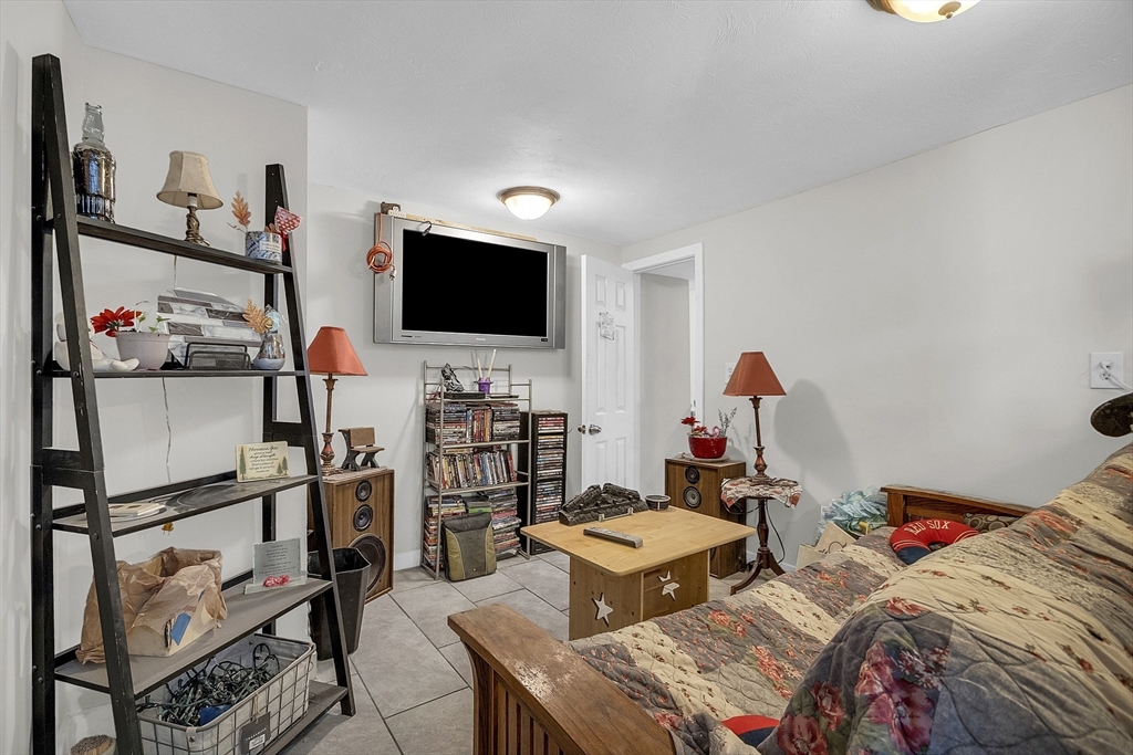 73 Ash Street Gardner, MA 01440 - Photo 16 of 40 a bedroom with a bed and a flat screen tv