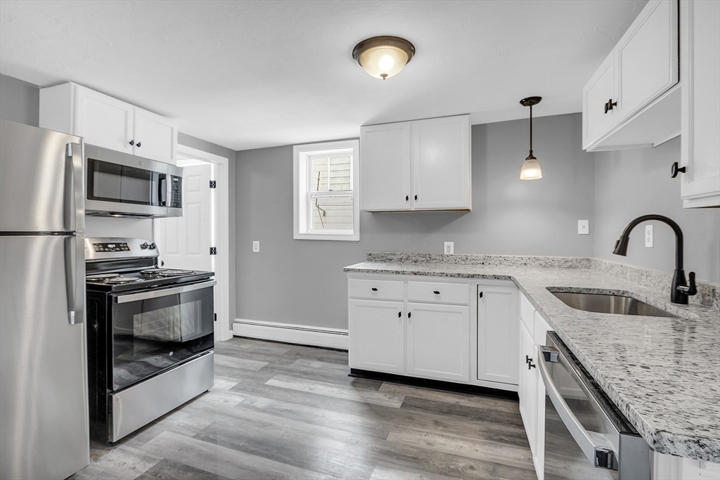 73 Ash Street Gardner, MA 01440 - Photo 18 of 40 a kitchen with granite countertop a sink stainless steel appliances and cabinets
