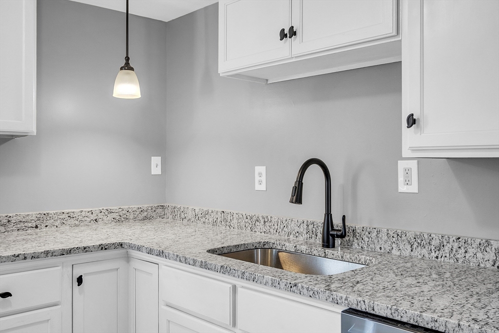 73 Ash Street Gardner, MA 01440 - Photo 19 of 40 a close view of a sink and a vanity in the bathroom
