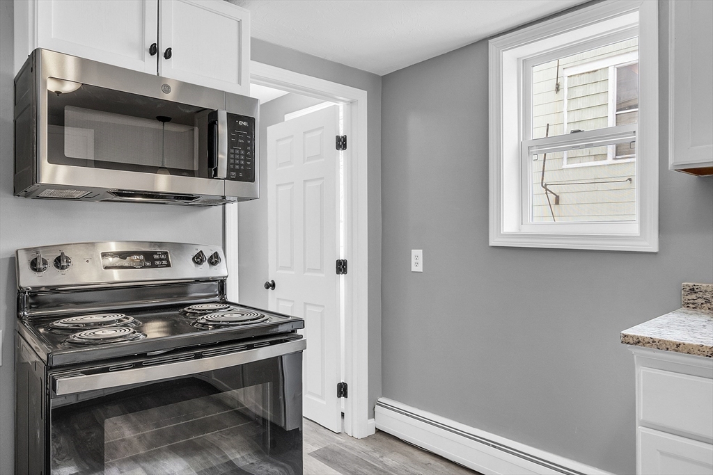 73 Ash Street Gardner, MA 01440 - Photo 21 of 40 a kitchen with a stove and a microwave