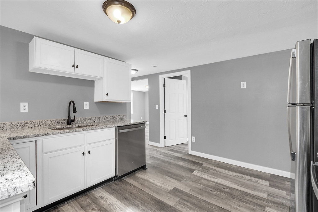 73 Ash Street Gardner, MA 01440 - Photo 22 of 40 a kitchen with granite countertop a sink and cabinets