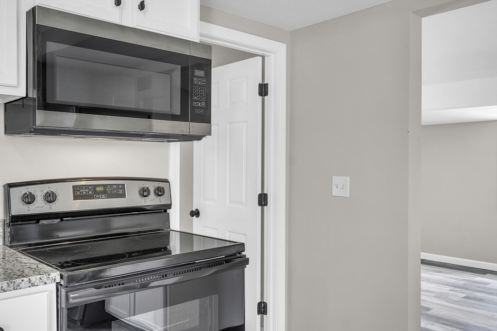 73 Ash Street Gardner, MA 01440 - Photo 4 of 40 a kitchen with a stove and a microwave
