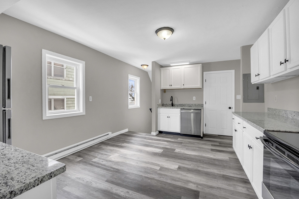 73 Ash Street Gardner, MA 01440 - Photo 5 of 40 a kitchen with stainless steel appliances granite countertop a stove a sink and a refrigerator