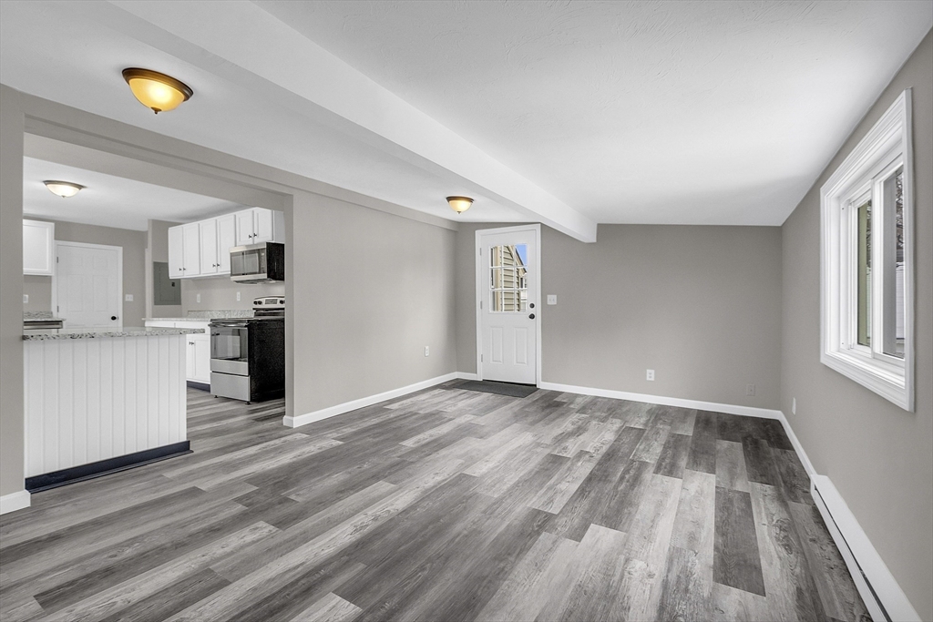 73 Ash Street Gardner, MA 01440 - Photo 6 of 40 a view of a kitchen with wooden floor and a window