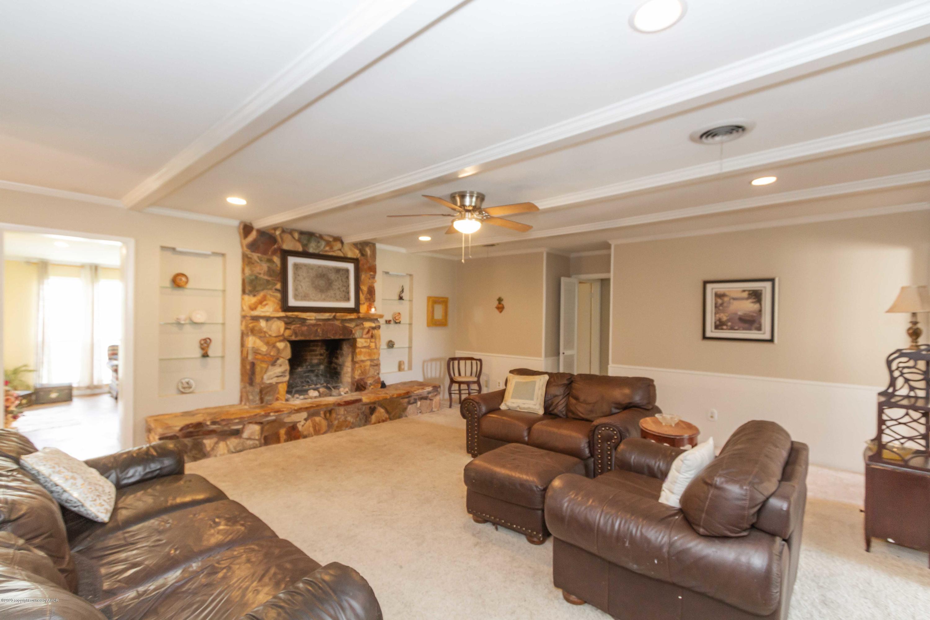 7206 Calumet Road Amarillo, TX 79106 - Photo 3 of 44 a living room with fireplace furniture and a chandelier