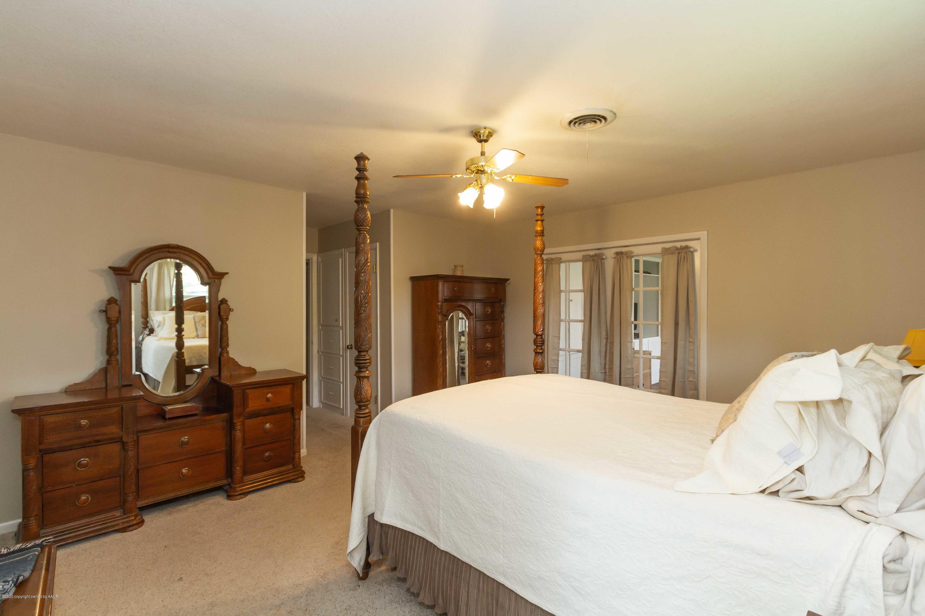7206 Calumet Road Amarillo, TX 79106 - Photo 23 of 44 a bedroom with a bed and a dresser
