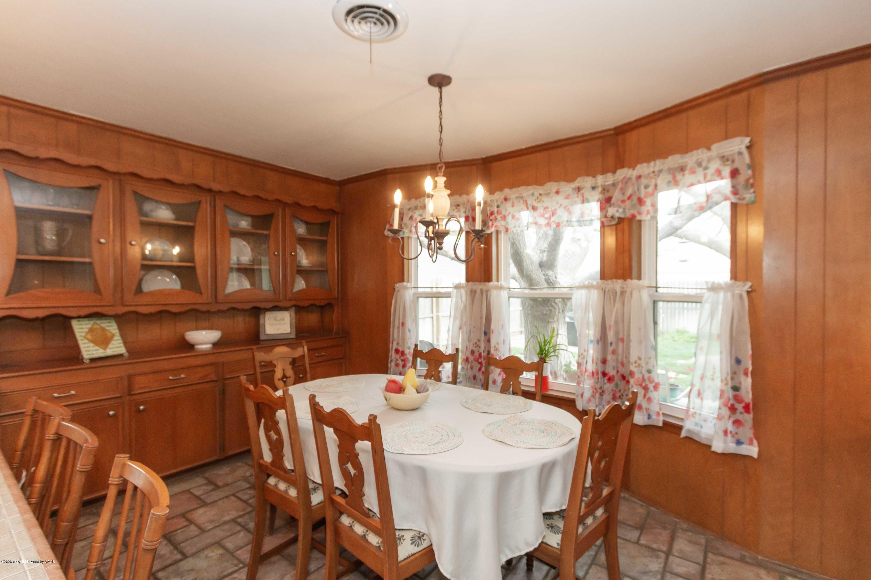 7206 Calumet Road Amarillo, TX 79106 - Photo 6 of 44 a dining room with furniture a chandelier and window