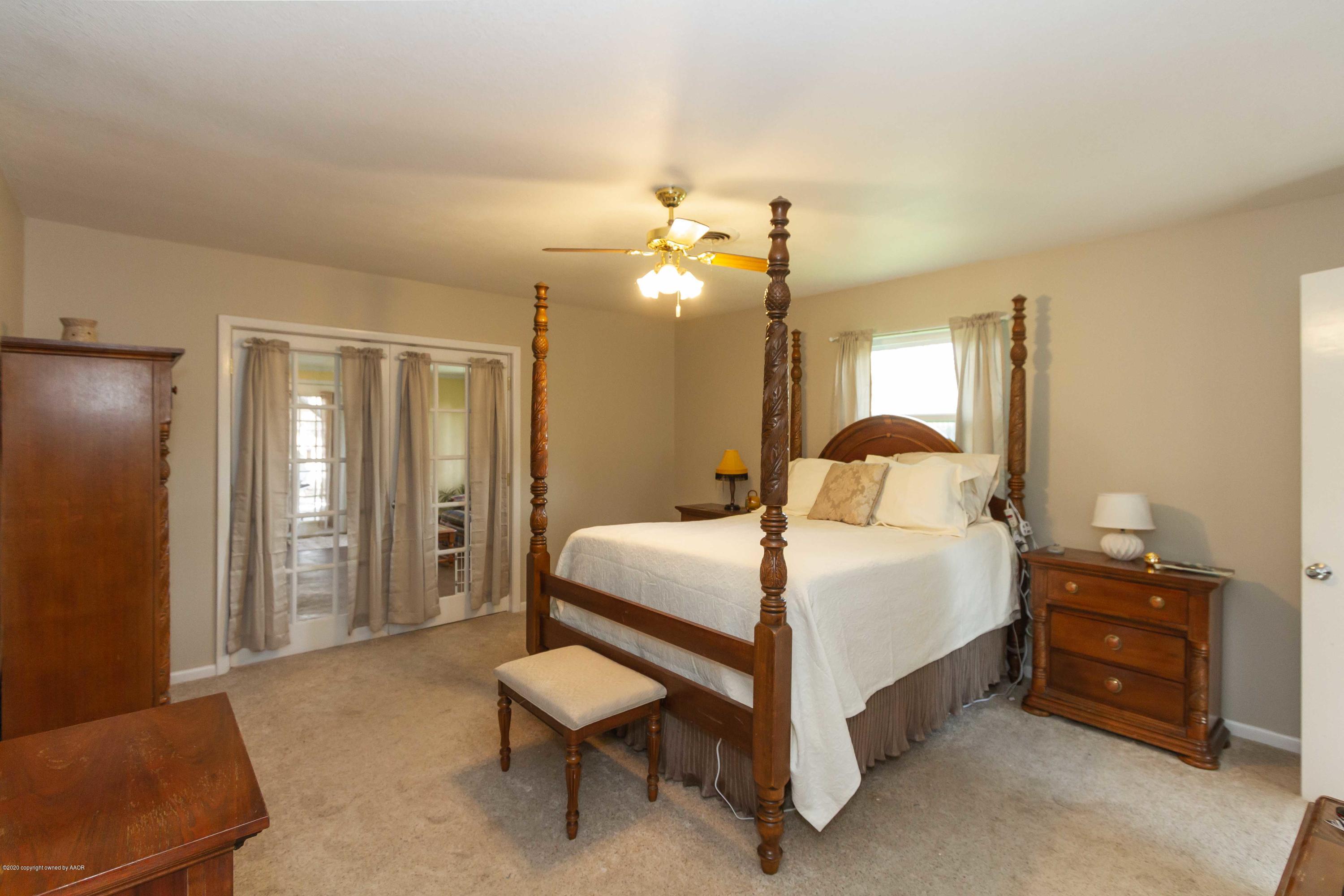 7206 Calumet Road Amarillo, TX 79106 - Photo 7 of 44 a bedroom with a bed and a chandelier