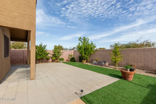 a view of a backyard with sitting area