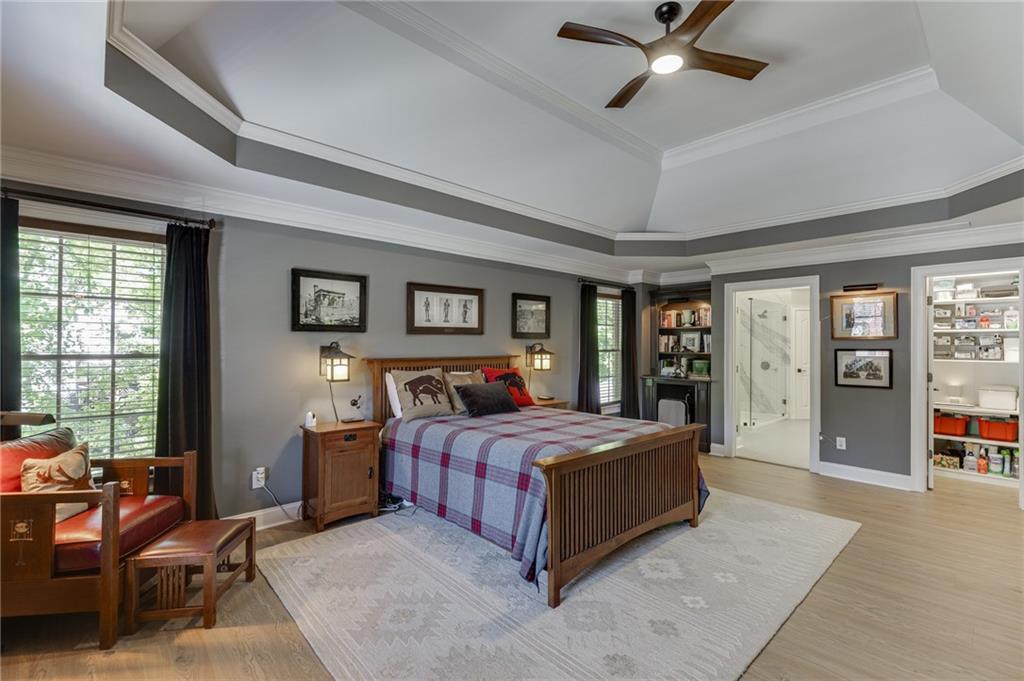 2758 Pathview Drive Dacula, GA 30019 - Photo 30 of 48 a bedroom with a large bed and a chandelier fan