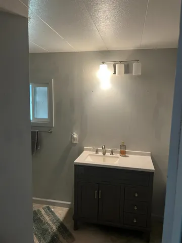 a bathroom with a sink vanity and a mirror