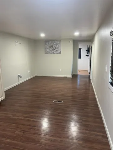 a view of a room with wooden floors and led lights