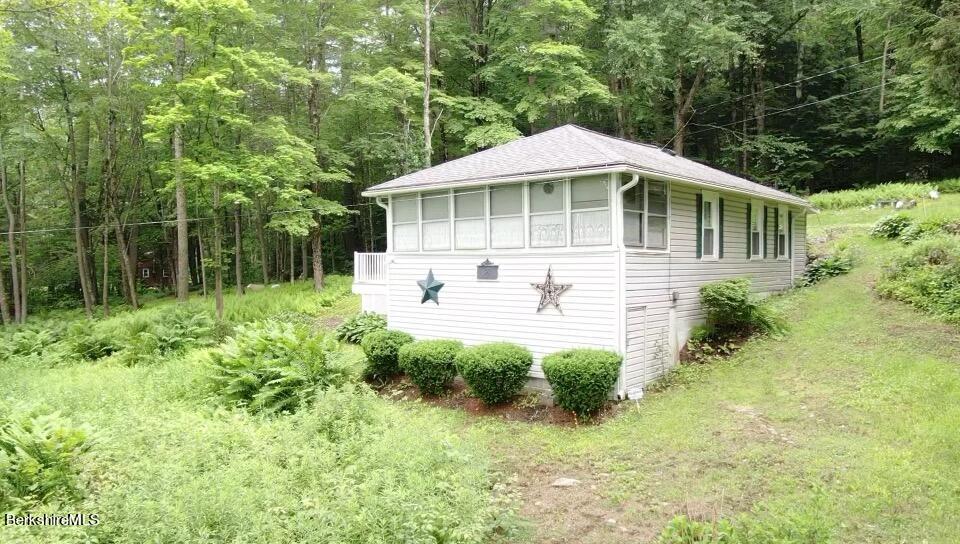 100 Highland Road Becket, MA 01223 - Photo 1 of 22 a front view of a house with yard and green space