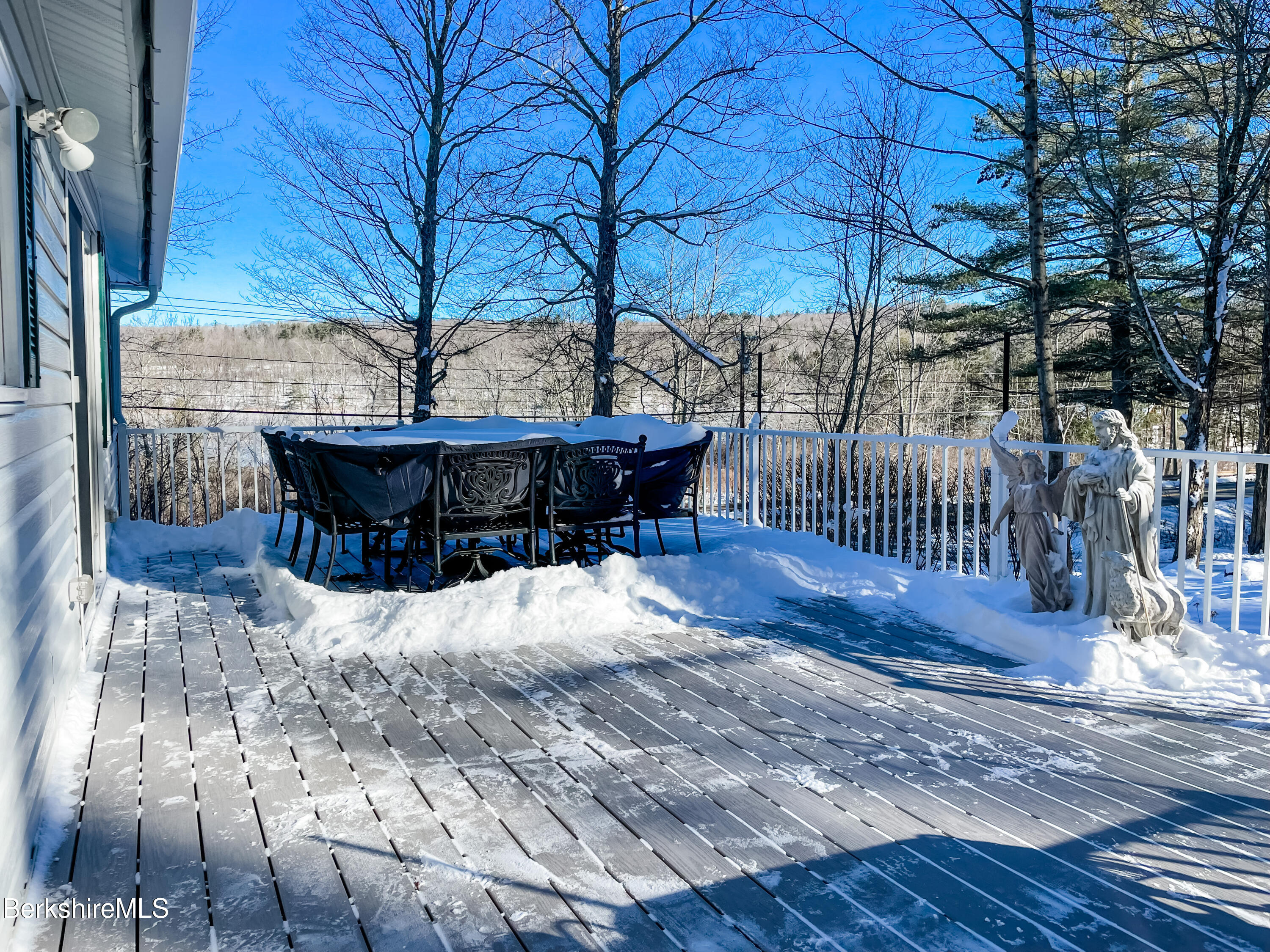 100 Highland Road Becket, MA 01223 - Photo 17 of 22 a view of a roof deck with wooden fence and a couple of chairs