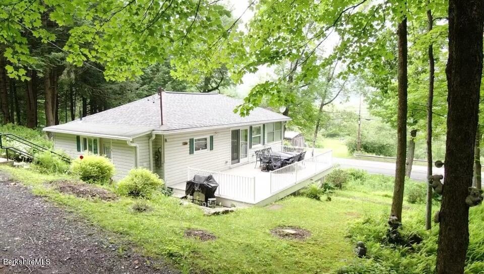100 Highland Road Becket, MA 01223 - Photo 3 of 22 a front view of a house with garden