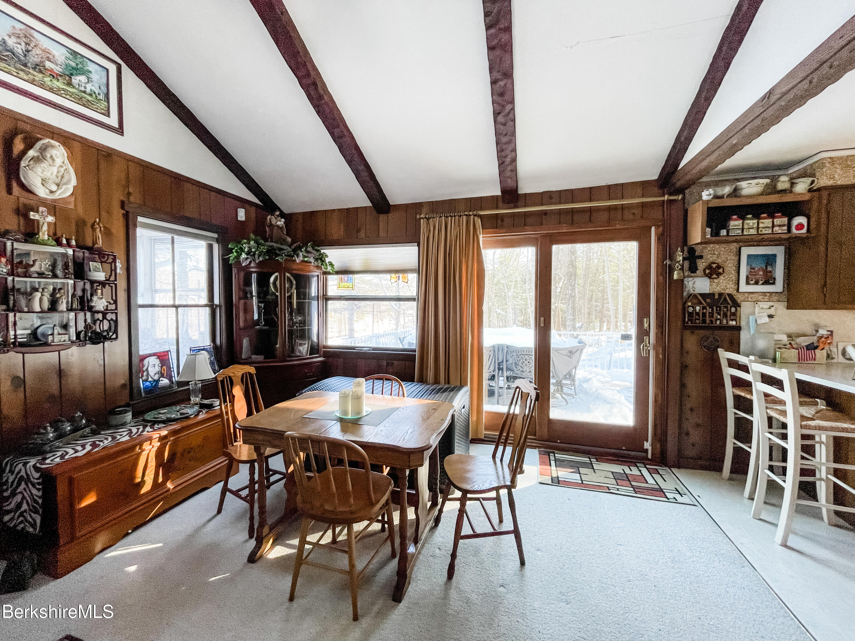 100 Highland Road Becket, MA 01223 - Photo 6 of 22 a dining room with furniture a rug a flat screen tv and a large window