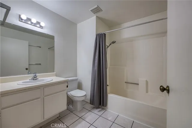 a bathroom with a double vanity sink toilet mirror and shower
