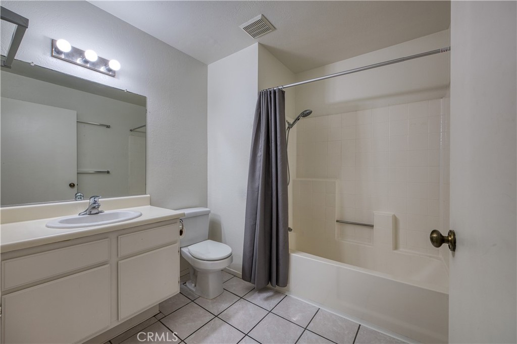 321 Inger Drive, Unit G55 Santa Maria, CA 93454 - Photo 13 of 16 a bathroom with a double vanity sink toilet mirror and shower