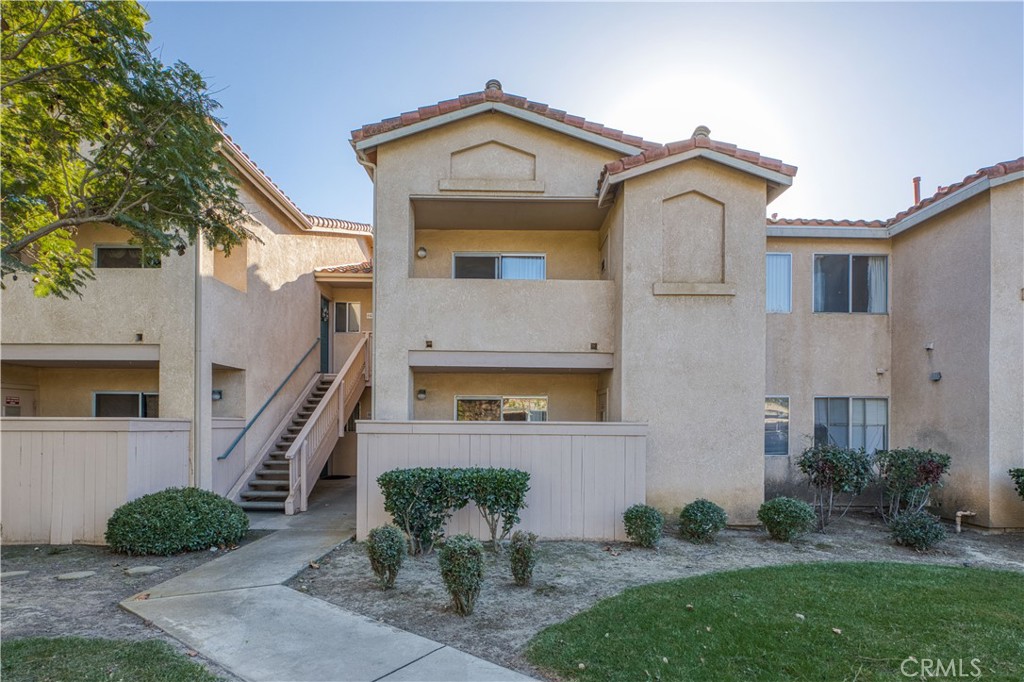 321 Inger Drive, Unit G55 Santa Maria, CA 93454 - Photo 2 of 16 a front view of a house with a yard
