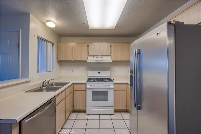 a kitchen with a stove sink and refrigerator