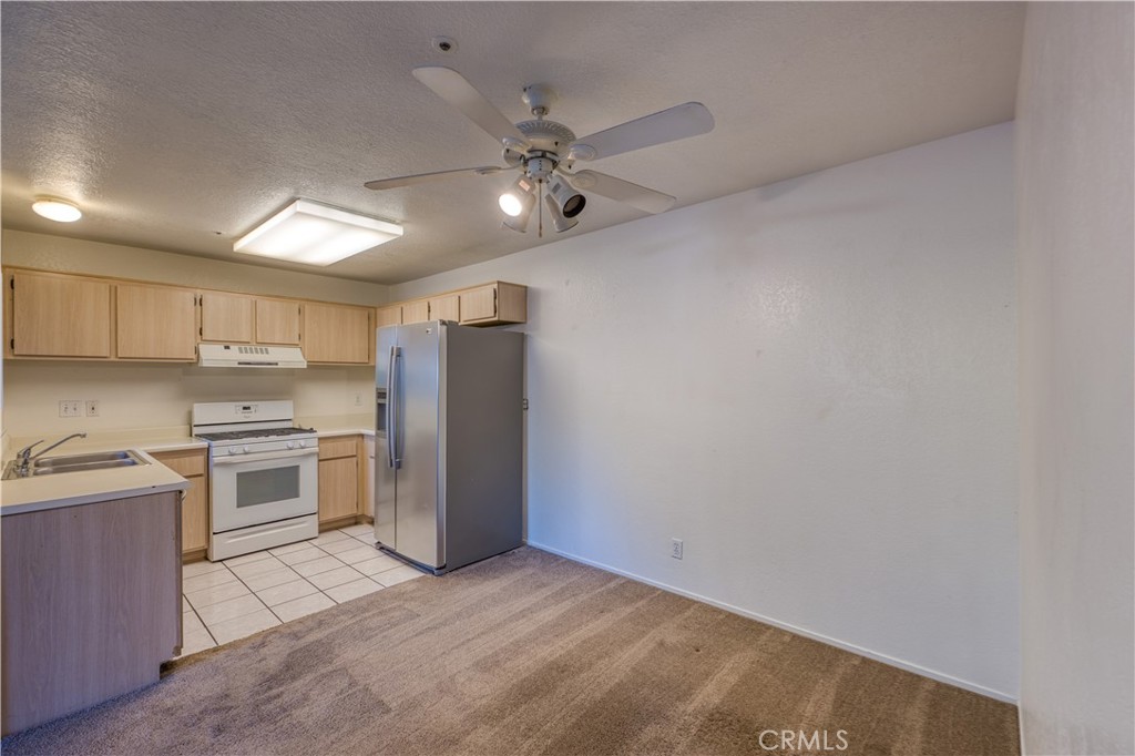 321 Inger Drive, Unit G55 Santa Maria, CA 93454 - Photo 5 of 16 a kitchen with a stove and a refrigerator
