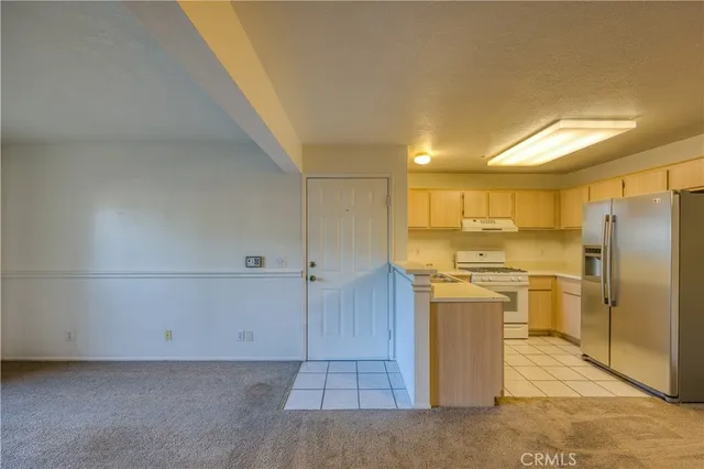 a kitchen with stainless steel appliances a refrigerator and a stove