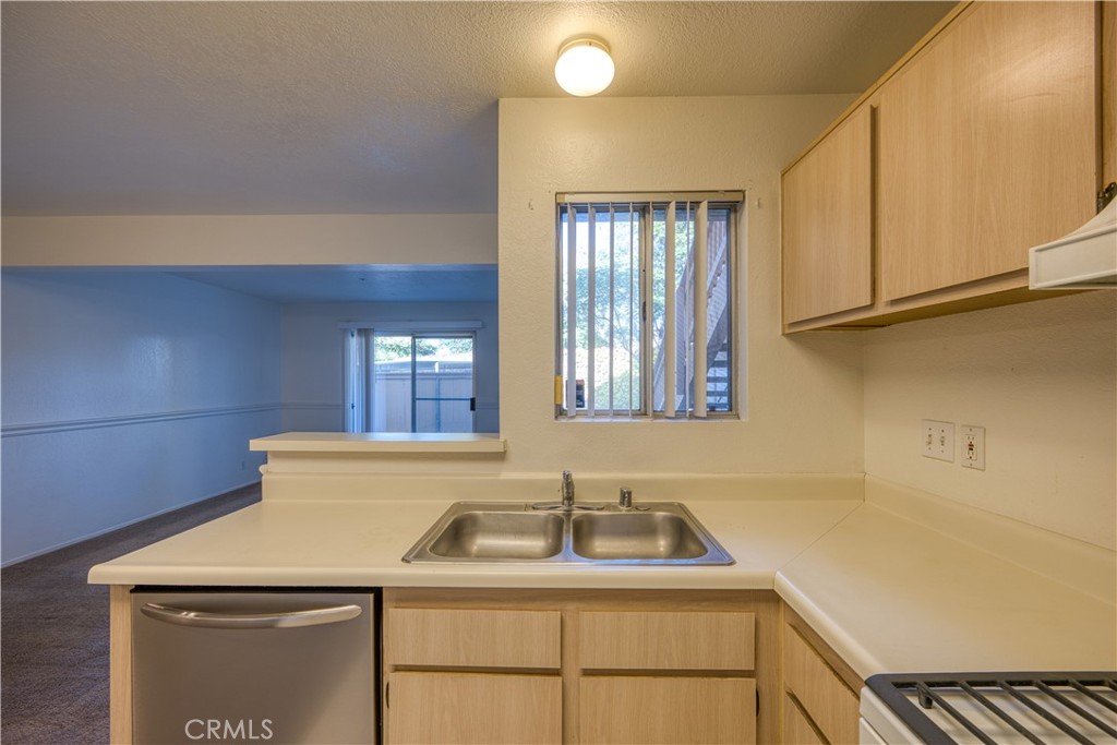 321 Inger Drive, Unit G55 Santa Maria, CA 93454 - Photo 9 of 16 a kitchen with a sink cabinets and window