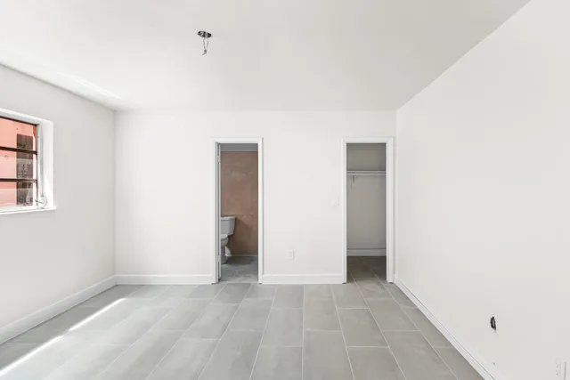 a view of an empty room with a window