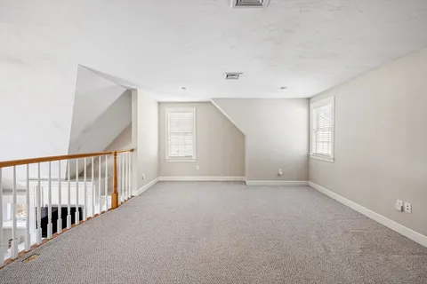 a view of an empty room with stairs