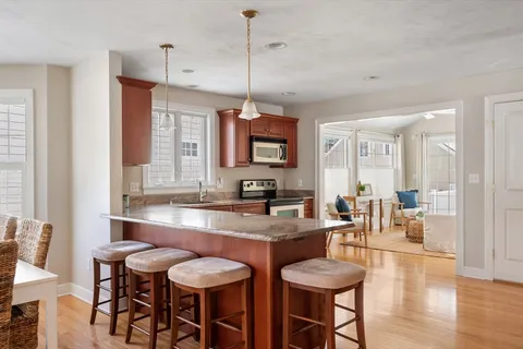 a large kitchen with a table and chairs