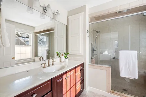 a bathroom with a sink a mirror and a shower