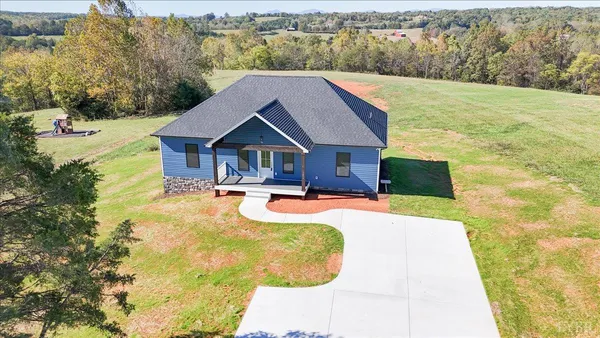 a view of a house with pool and a yard